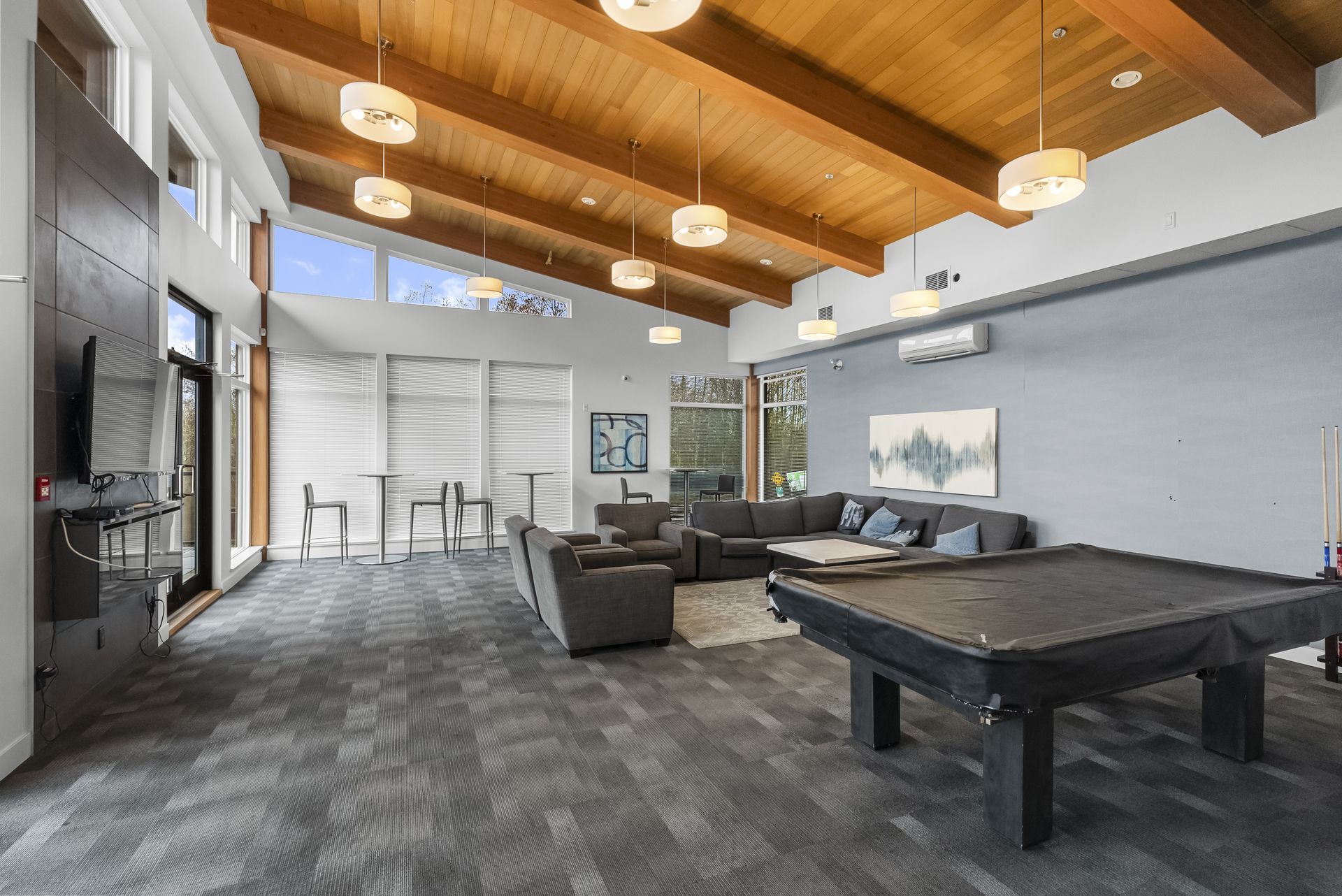 Lounge with a wood plank ceiling and a pool table