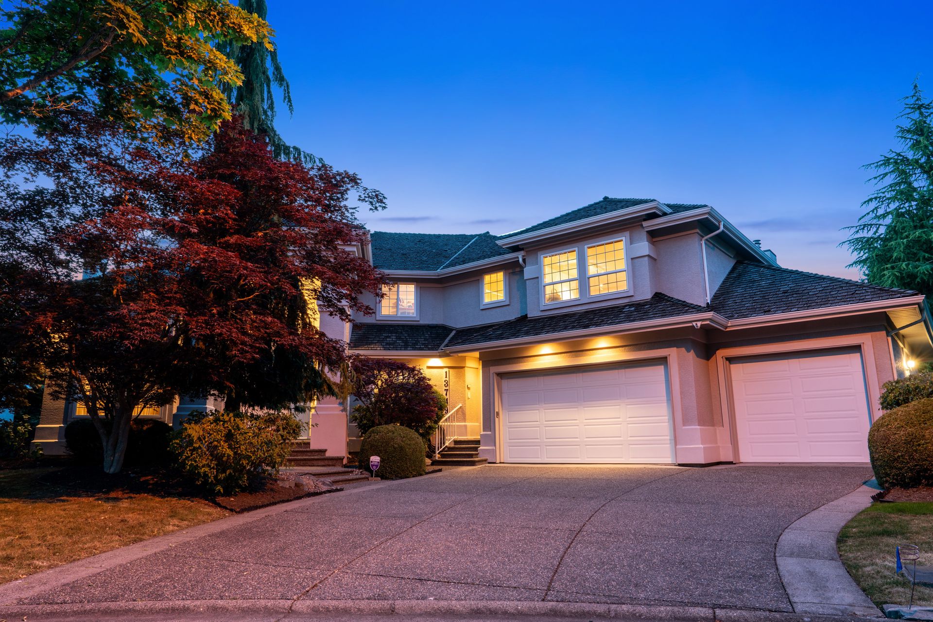 Twilight front exterior with the triple garage