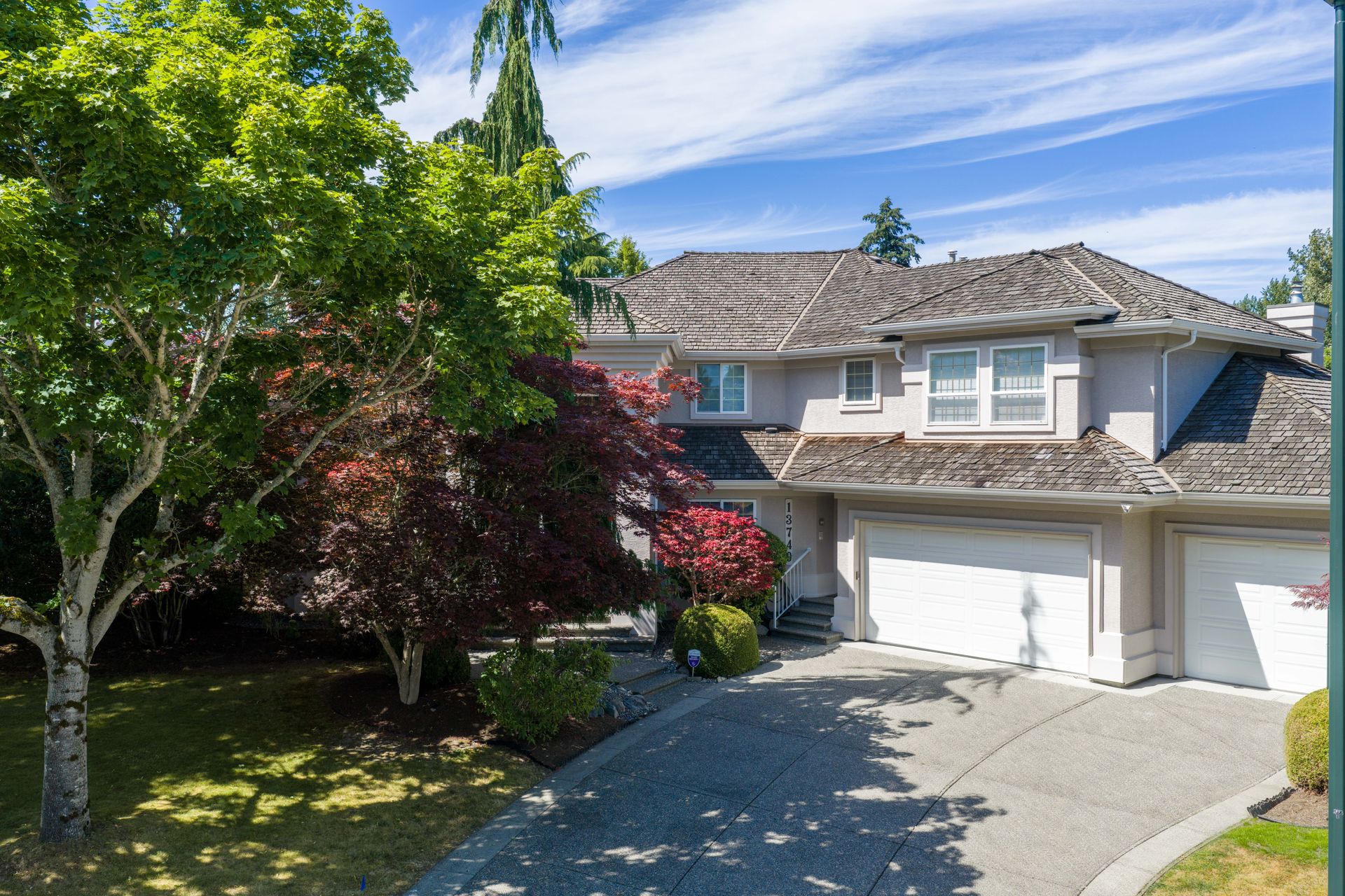 Front of the home framed by mature trees