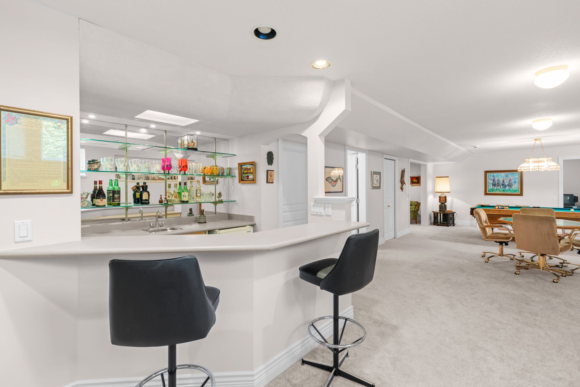 Wet bar with stools beside the games room