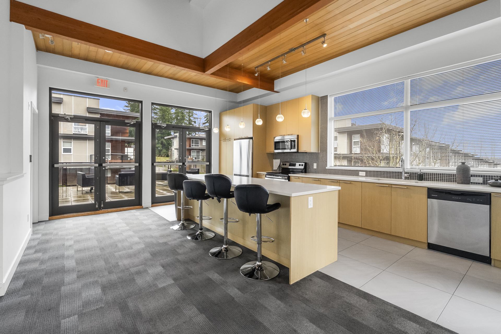 Open lounge with a wood ceiling and big windows