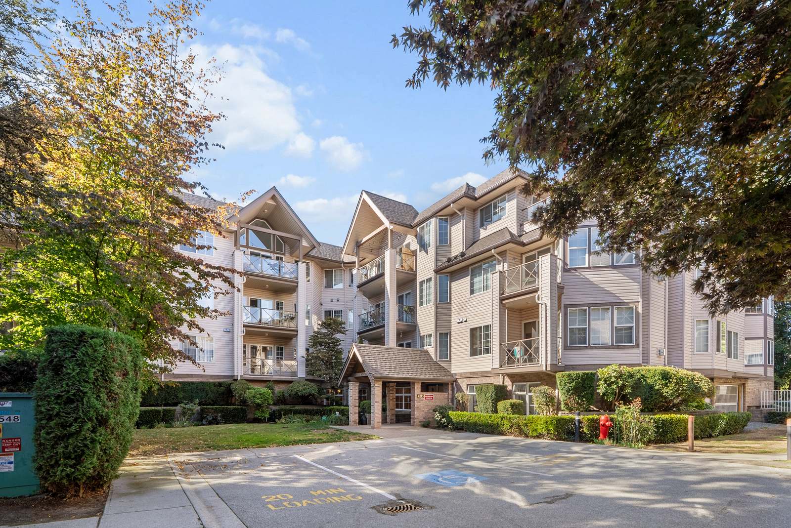 Building exterior with mature trees